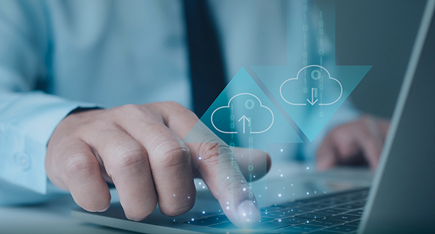 Businessman operating laptop with virtual cloud computing icons, symbolizing smart cloud-based data management and remote control.