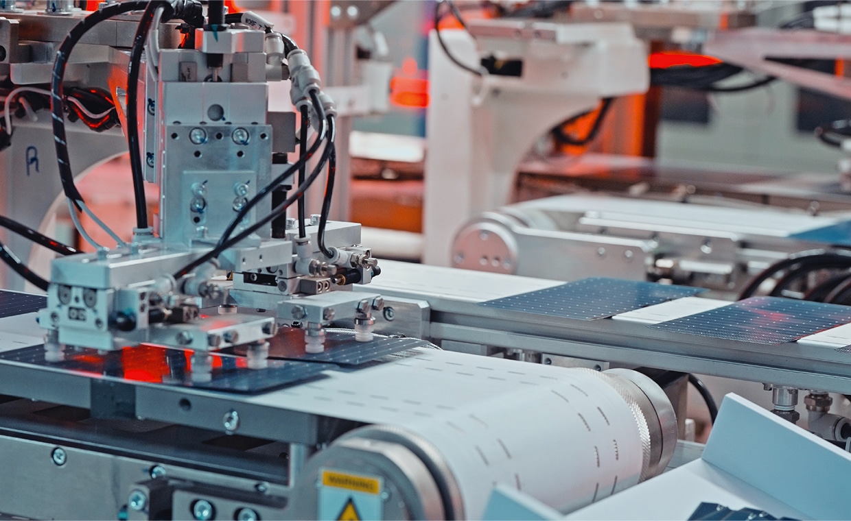 Automated robotic equipment assembling photovoltaic cells in a high-tech solar panel production line