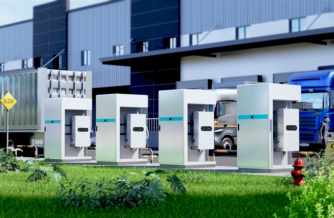 The image shows several solavita energy storage units placed outside a warehouse, with trucks parked in the background. A "SLOW" sign is visible in the foreground, and a fire hydrant is placed near the plants.