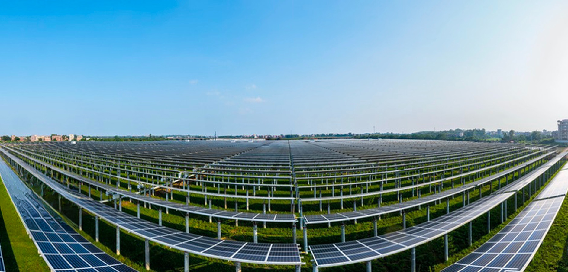 Solavita solar farm featuring rows of ground-mounted photovoltaic panels under clear blue sky, highlighting Solavita’s renewable energy solutions and large-scale solar power generation